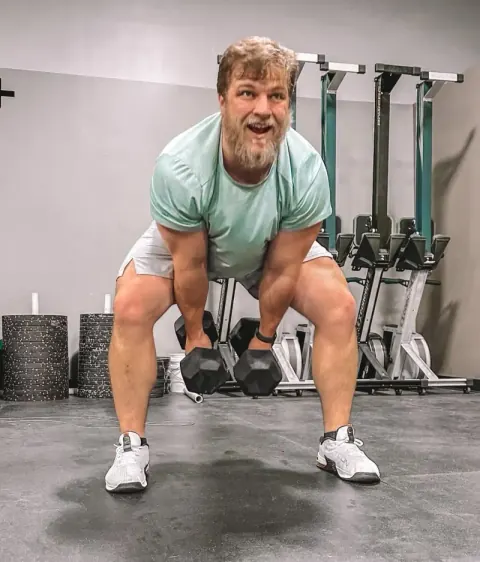 Athlete training with dumbbells at CrossFit Momentous